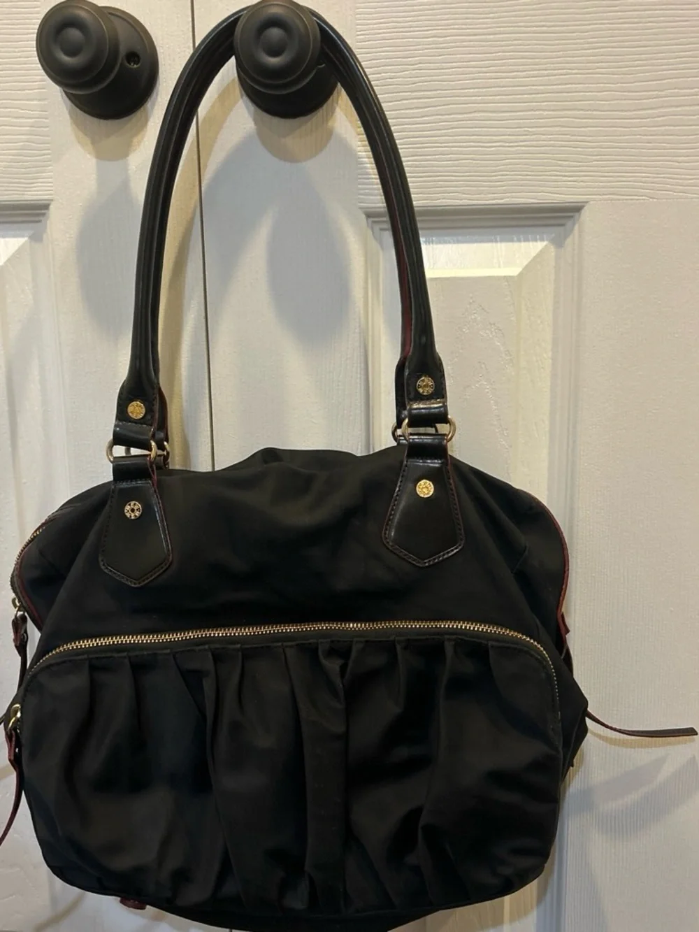 MZ Wallace Black Shoulder Bag with Gold and red Accents and pink interior